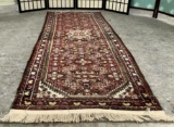 Red wool carpet w/ fringe & floral designs, approx. 62x30 inches.