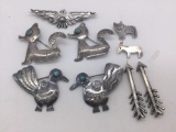 Nine sterling silver tested brooches, some with turquoise. Largest approx 2x1.5 inches. Ttw 40.4 g.