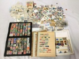 Huge lot of loose US and foreign stamps. Thousands of stamps! Largest book measures approx 12x9.5 in