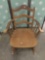 Vintage wide wooden rocking chair.