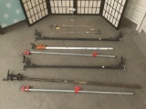 6 long metal clamps & two Italian car rack pieces, largest approx. 62x5x4 inches.