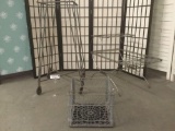 Three vintage metal items, incl. a stand w/casters, a two tiered end table & a crate.