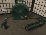Melnor compact hose reel w/ connectors & Melnor nozzle, approx. 22x3x17 inches.