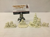 Collection of four Department 56 pewter figurines of winter scenes.