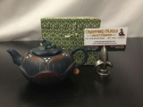 Stamped Chinese teapot with frog motif.
