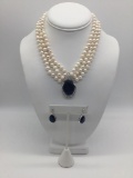 Three strand white Akoya style pearl necklace with matching earrings.