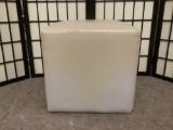 Cream colored cube ottoman, approx. 16x16x16 inches.
