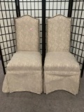 Pair of cushioned/upholstered dining chairs w/studs. Approx. 19x23x42 inches each.