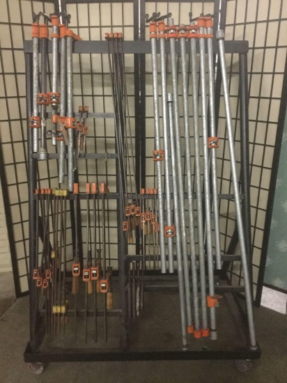 Rolling metal rack filled w/ 40 misc. clamps, see pics. Approx. 66x45x29 inches.