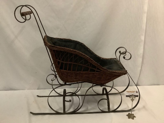 Vintage wicker and metal doll sized sleigh carriage. Approx 35x33x11 inches.