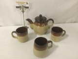 Earth tone tea set w/small teapot & three cups, approx. 9x6x6 inches.