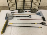 7 yard tools in plastic trash bin: snow shovels, brooms, rakes and more.