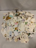Large box collection of hundreds of vintage/modern US postage stamps on envelope pieces.