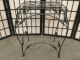 Metal plant stand w/ floral motif, approx. 21x17x13 inches.