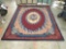 Beaulieu Rugs 100% olefin pile area rug w/ floral designs & worn fringe, shows wear