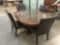 Wooden dining table w/1 leaf, glass top, & 4 faux-leather chairs Approx. 66x49x31 expanded