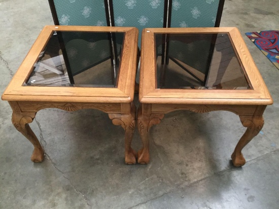 Pair of tinted glass top wood end tables. Approx 27x24x20 inches.