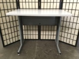 Gray desk w/ metal base. Approx. 36x24x30 inches.