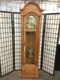 Howard Miller Tempos Fugit grandfather clock in fine oak case .