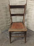 Antique chair with pressed leather seat.