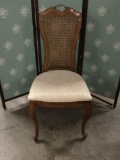 Upholstered rattan back dining chair.