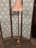 Modern brass tone standing lamp w/ shade. Tested and working. Approx 61x14x14 inches.