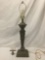 Vintage metal table lamp with faces.