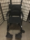 Probasics black folding wheel chair w/ foot rests, looks unused