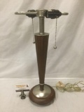 Modern wood and metal base table lamp.