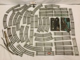 Collection of model train tracks with switcher and transformer base
