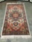 Vintage plush wool small rug with fiery red and cream design