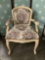 White upholstered arm chair with floral patterning. Approx 36x25x20 inches.