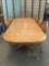 Vintage long oak dining table with 6 chairs, 2 leaves and footed trestle base