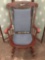Wooden rocking chair with cushions & floral bird designs.