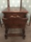 Rustic wooden side table with magazine rack and storage compartment.