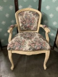 White upholstered arm chair with floral patterning. Approx 36x25x20 inches.