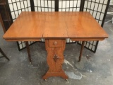 Antique oak turn of the century drop leaf kitchen table with single drawer and wheat design