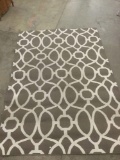 Outdoor rug with brown and white patterning, approx 126x86 inches.