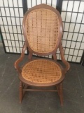 Vintage wood rocking chair with woven seat and back