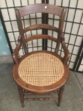 Vintage wood chair with woven wicker seat