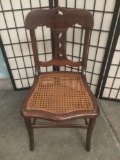 Vintage wood chair with woven wicker seat