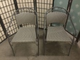 Pair of matching patio chairs with metal frame & woven seats