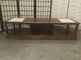 Wood coffee table w/two inlaid slabs of granite. Approx. 59x21x15 inches....