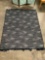 Threshold navy blue patio rug with fringe in good condition, approximately 60 x 81 inches.