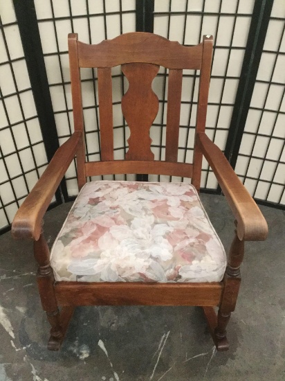 Vintage wood rocking chair with floral upholstered seat cushion