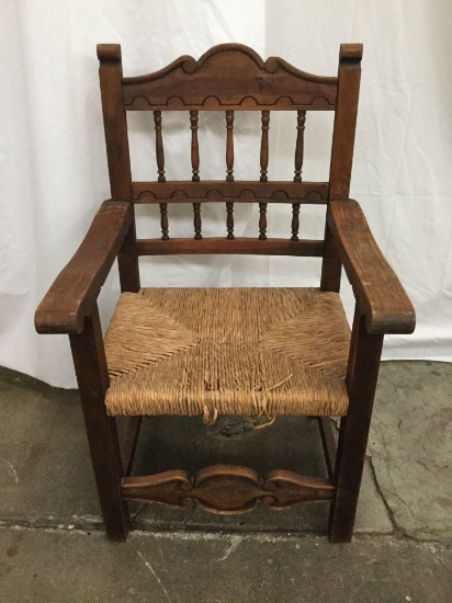 Vintage wood carved arm chair w/woven seat