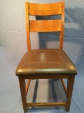 Wood chair w/ leather upholstered seat, approx. 21 x 20 x 42 inches.