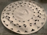 Circular and woven wall patio rug, approximately 71 inches round.