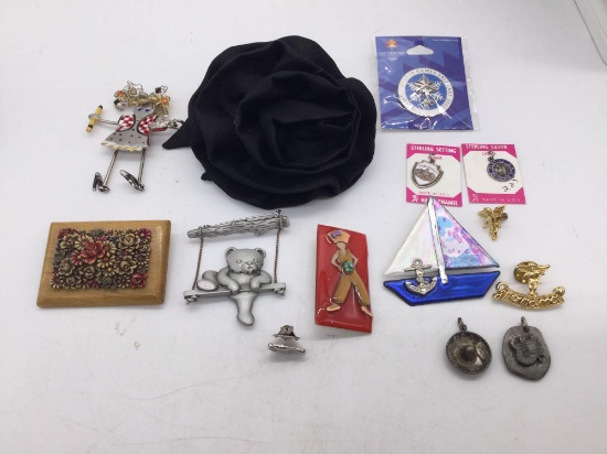 Collection of 14 brooches, pins, and pendants