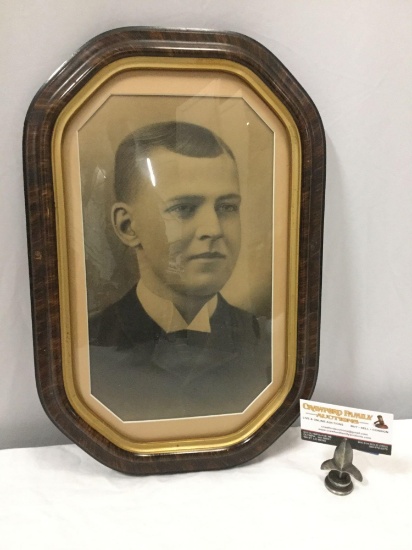 Antique domed glass picture frame with portrait of a young man, approximately 12 x 17.5 in.